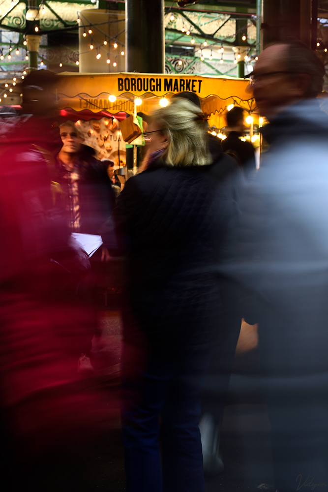 This a long exposure image of people walking in the prominent Borough Market in London