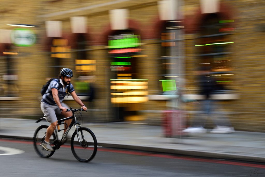 This is a panning of image of a person riding a cycle in London